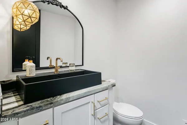 a bathroom with a sink a mirror and shower