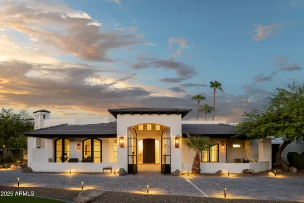 a view of house with yard and car parked