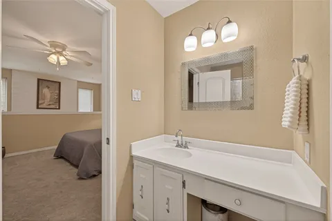 a bathroom with a toilet a sink and mirror