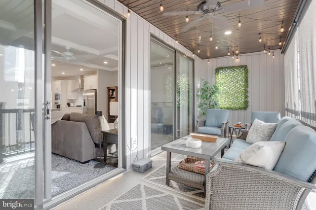 a living room with furniture and a floor to ceiling window
