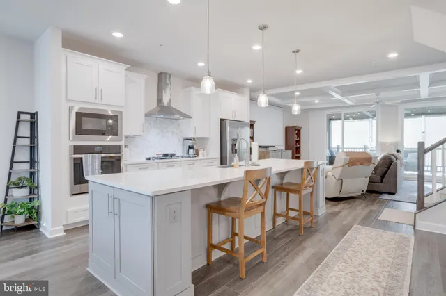 a large kitchen with kitchen island a sink table and chairs