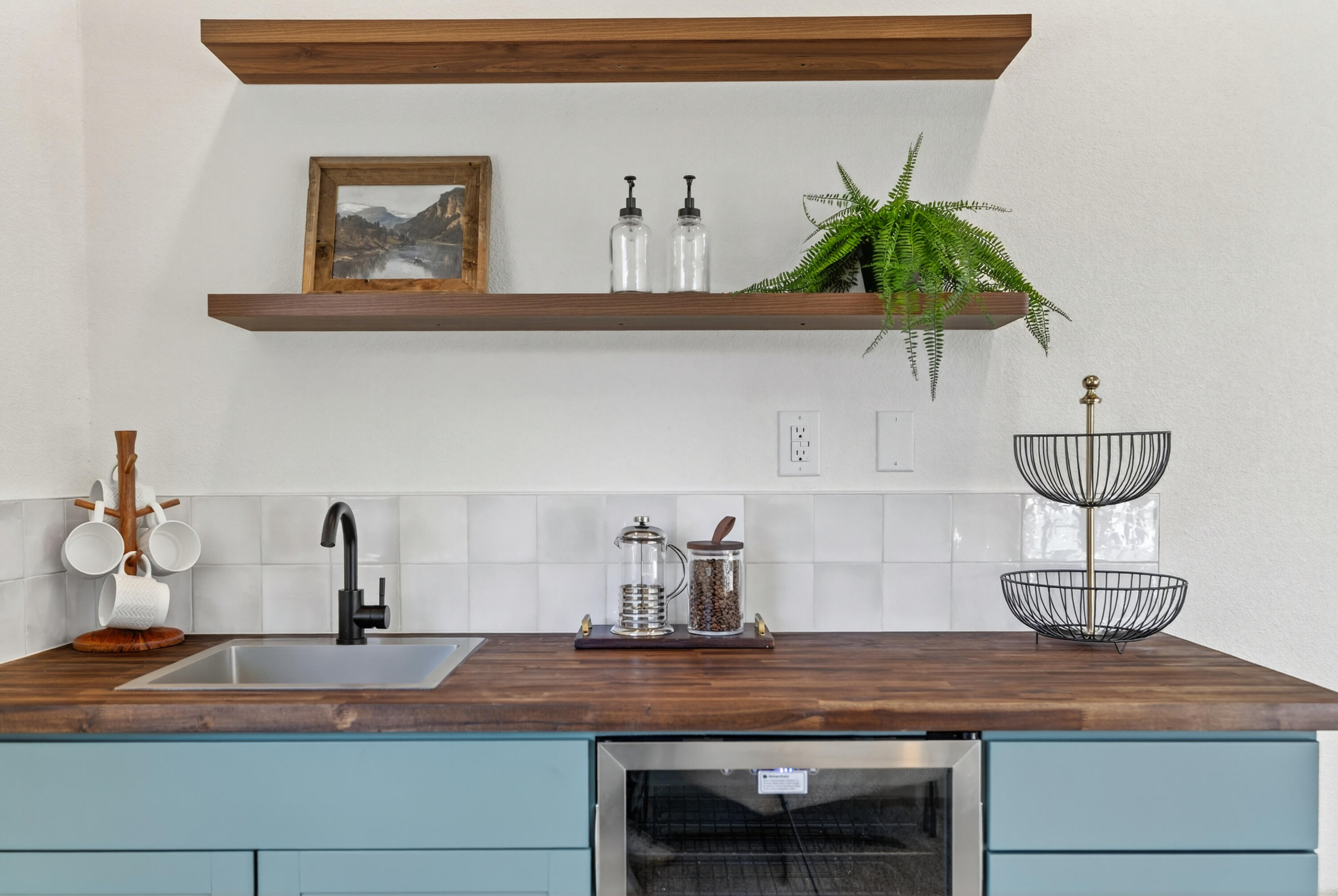 595 Rafael Street Redding, CA 96002 - Photo 19 of 54 a kitchen with a potted plant on the counter and cabinets