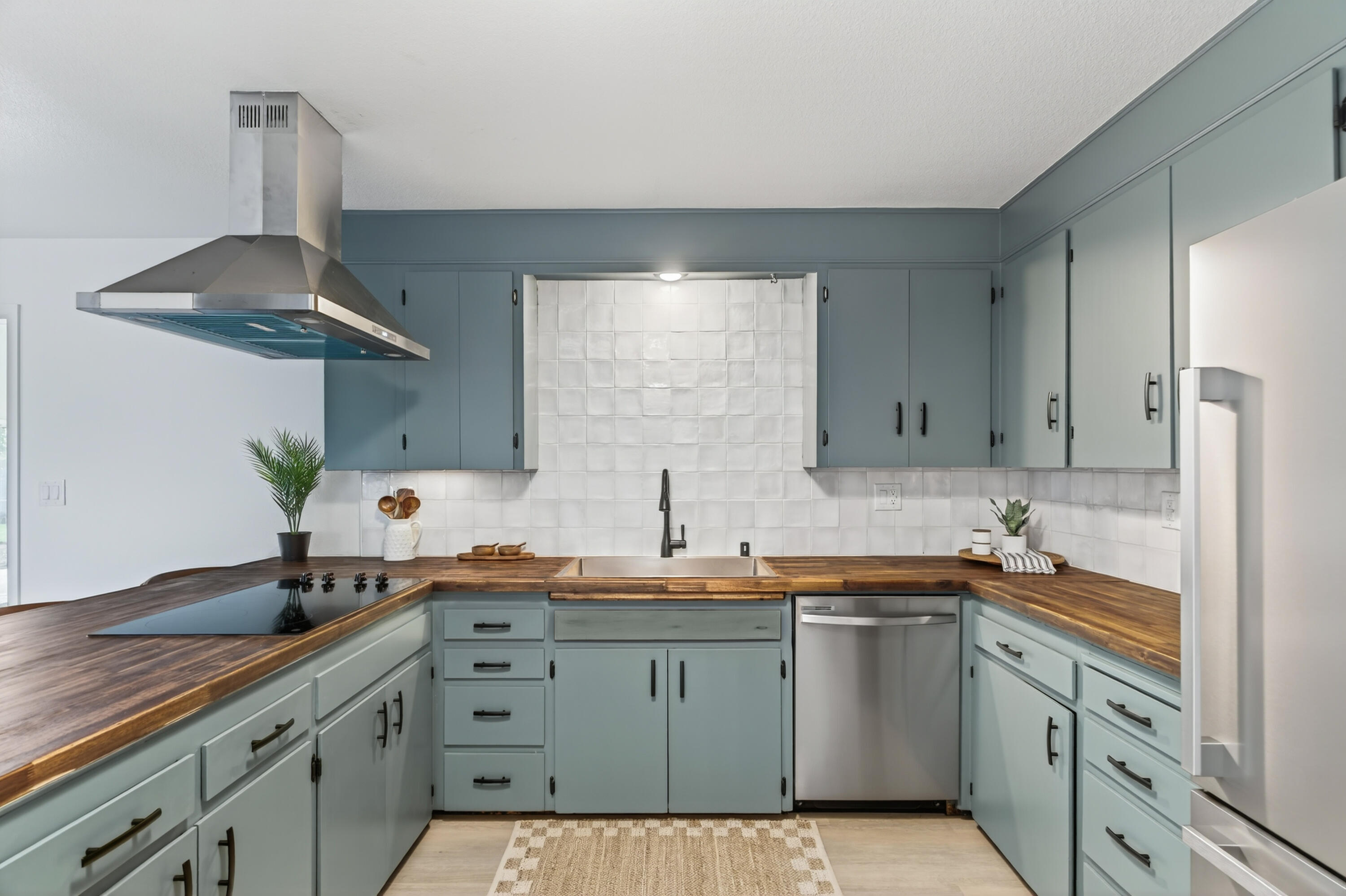 595 Rafael Street Redding, CA 96002 - Photo 23 of 54 a kitchen with a sink dishwasher a stove and white cabinets