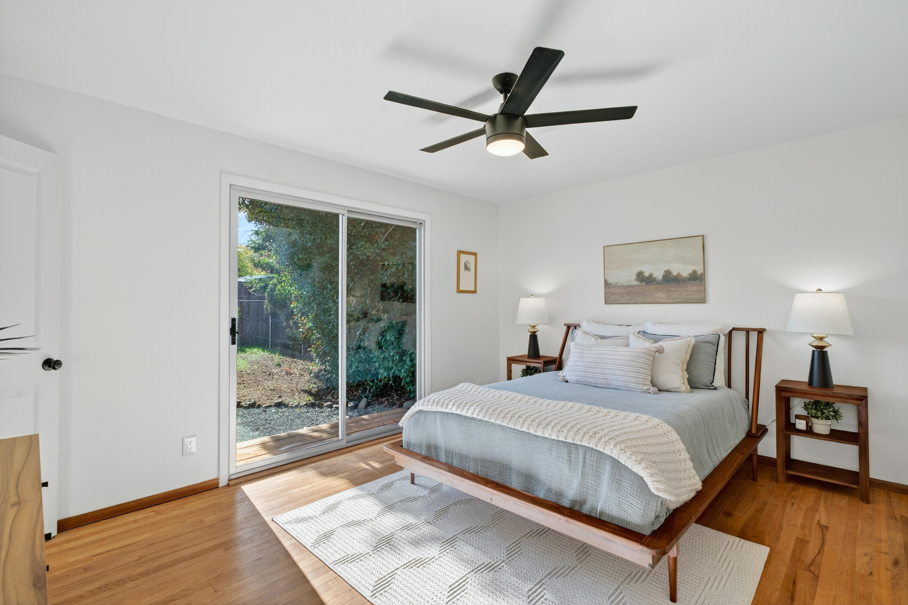 595 Rafael Street Redding, CA 96002 - Photo 29 of 54 a bedroom with a large bed and a glass window