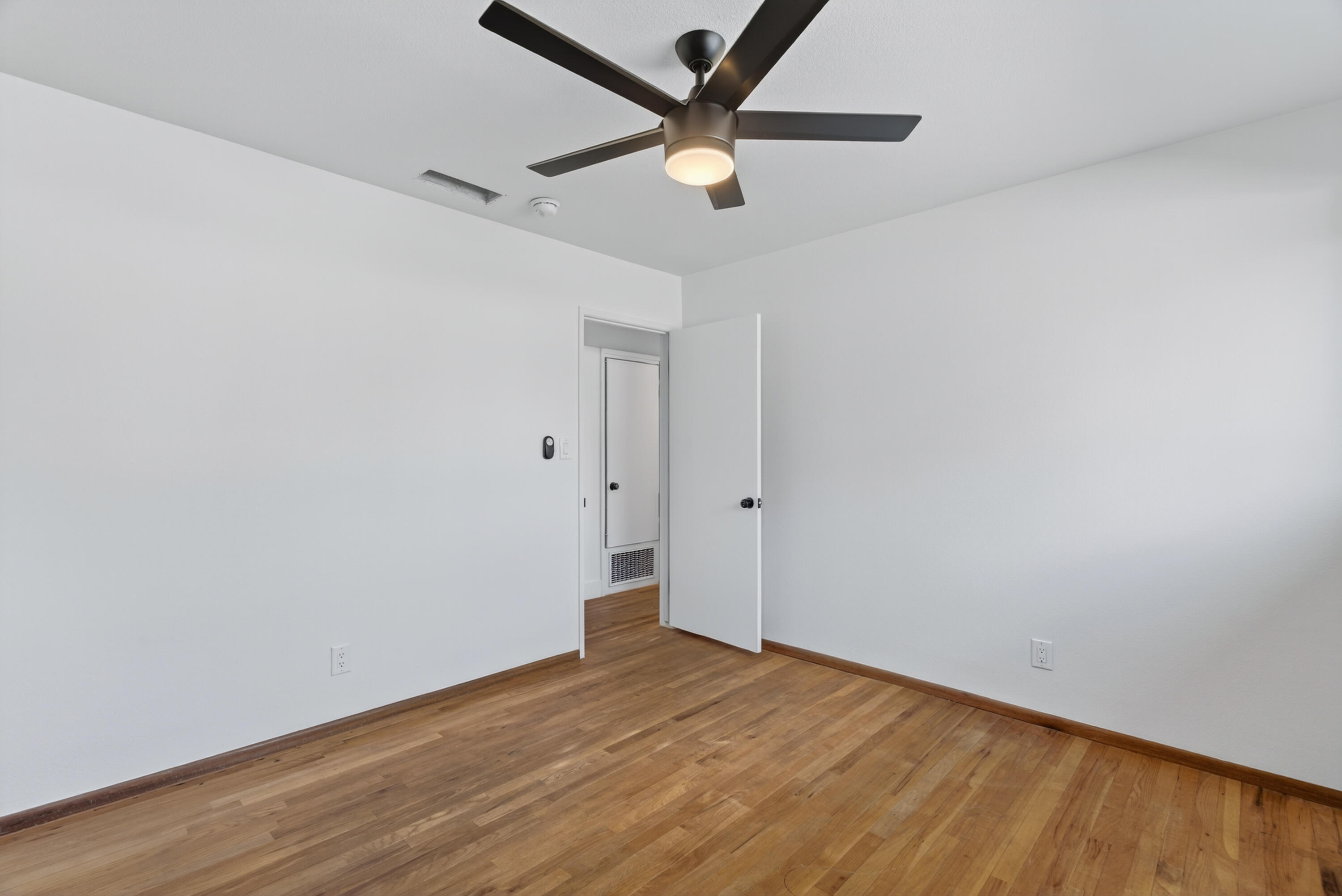 595 Rafael Street Redding, CA 96002 - Photo 45 of 54 an empty room with wooden floor and a ceiling fan