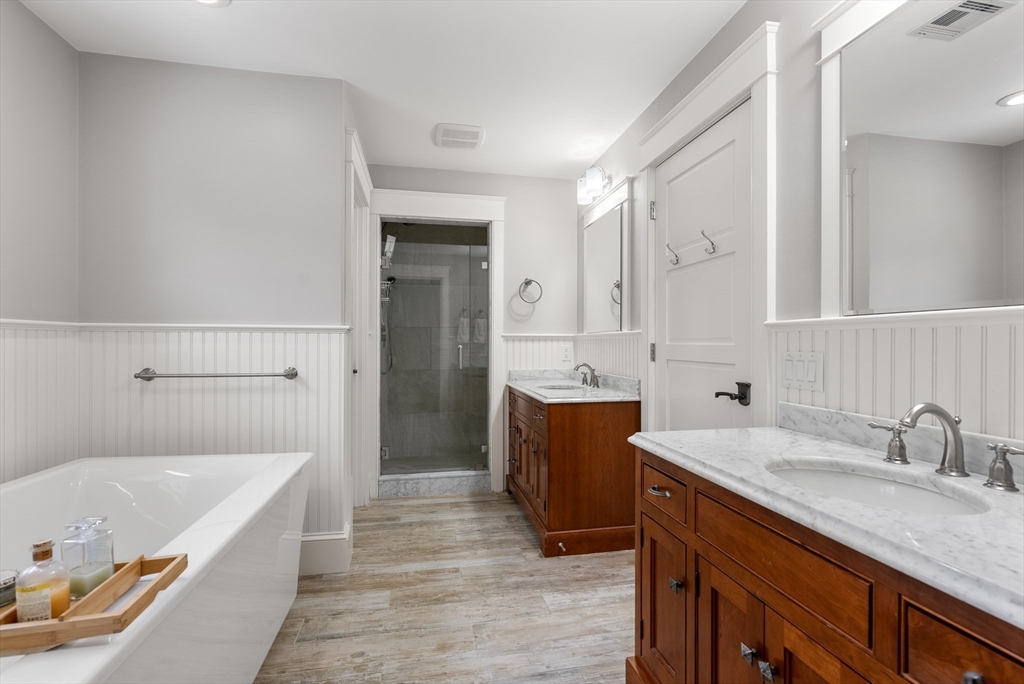 32 Standish Circle Wellesley, MA 02481 - Photo 16 of 41 a bathroom with a granite countertop bathtub a sink and a shower