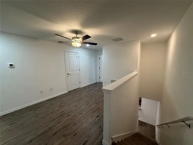 a view of entryway and hall with wooden floor