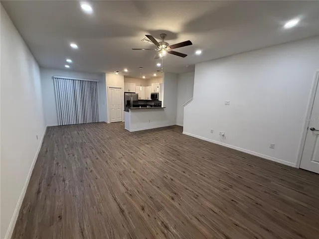 a view of a kitchen with a sink and wooden floor
