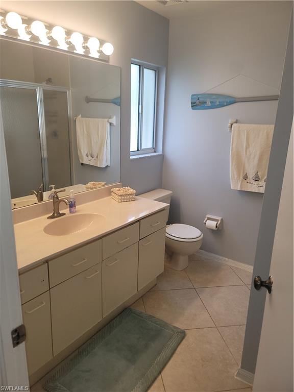 7731 Jewel Lane, Unit 204 Naples, FL 34109 - Photo 17 of 29 a bathroom with a sink toilet and mirror