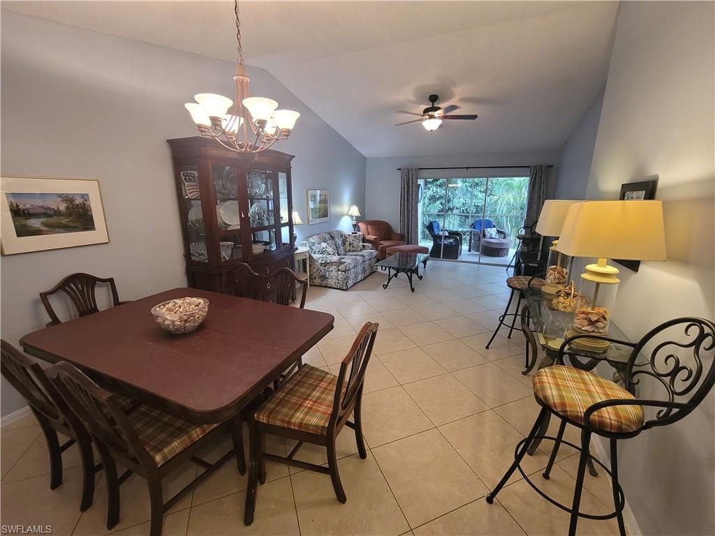 7731 Jewel Lane, Unit 204 Naples, FL 34109 - Photo 2 of 29 a view of a dining room with furniture and chandelier