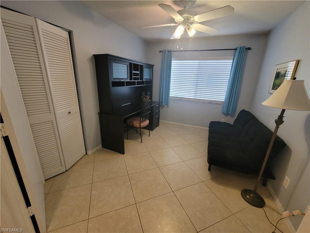 7731 Jewel Lane, Unit 204 Naples, FL 34109 - Photo 21 of 29 a living room with furniture and a flat screen tv
