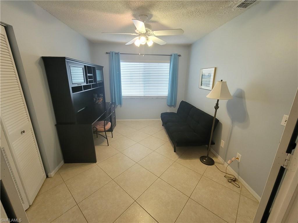 7731 Jewel Lane, Unit 204 Naples, FL 34109 - Photo 22 of 29 a living room with a couch and a flat screen tv