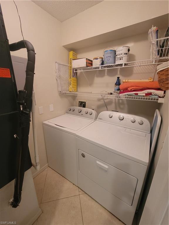 7731 Jewel Lane, Unit 204 Naples, FL 34109 - Photo 25 of 29 a utility room with dryer and washer