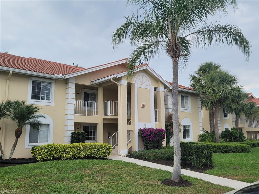 7731 Jewel Lane, Unit 204 Naples, FL 34109 - Photo 26 of 29 a front view of house with yard and green space