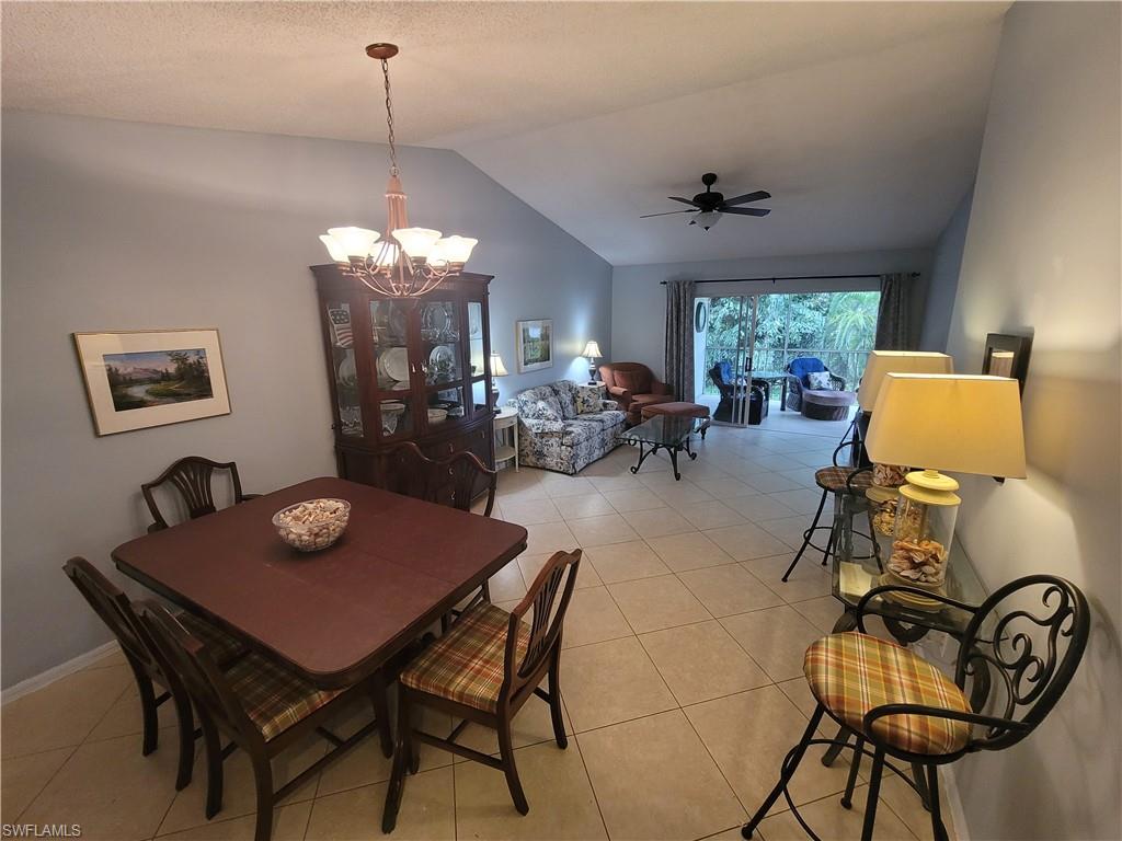 7731 Jewel Lane, Unit 204 Naples, FL 34109 - Photo 6 of 29 a view of a dining room with furniture and chandelier