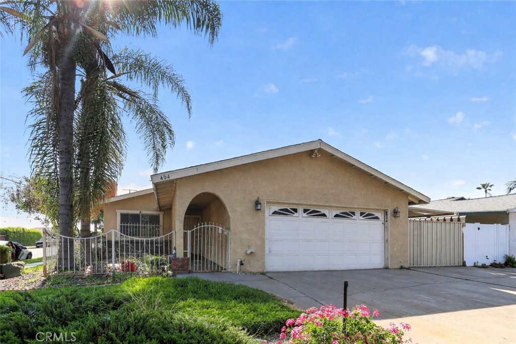 404 South 3rd Street Montebello, CA 90640 - Photo 1 of 29 a front view of a house with a yard and garage