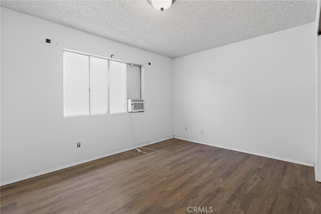 404 South 3rd Street Montebello, CA 90640 - Photo 12 of 29 a view of an empty room with wooden floor and a window