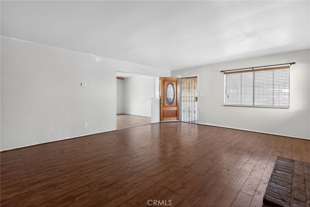 404 South 3rd Street Montebello, CA 90640 - Photo 2 of 29 an empty room with wooden floor and windows