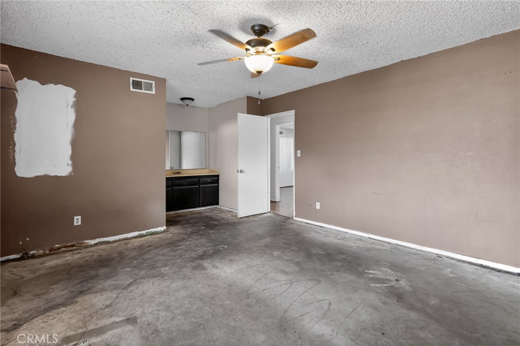 404 South 3rd Street Montebello, CA 90640 - Photo 21 of 29 a view of an empty room with a ceiling fan and window