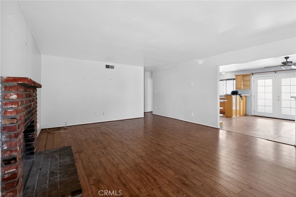 404 South 3rd Street Montebello, CA 90640 - Photo 3 of 29 an empty room with wooden floor and windows