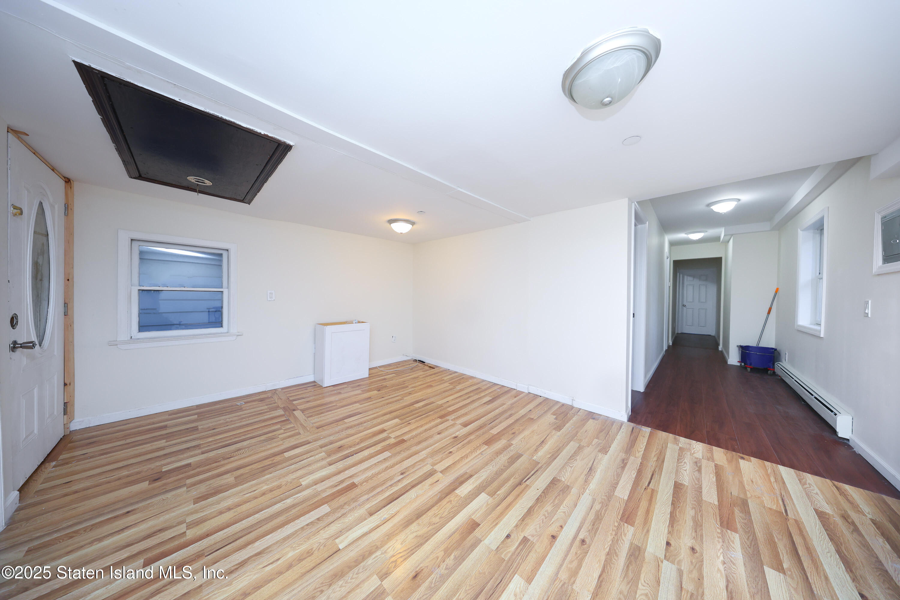 76 Simonson Avenue Staten Island, NY 10303 - Photo 11 of 21 a view of empty room with wooden floor