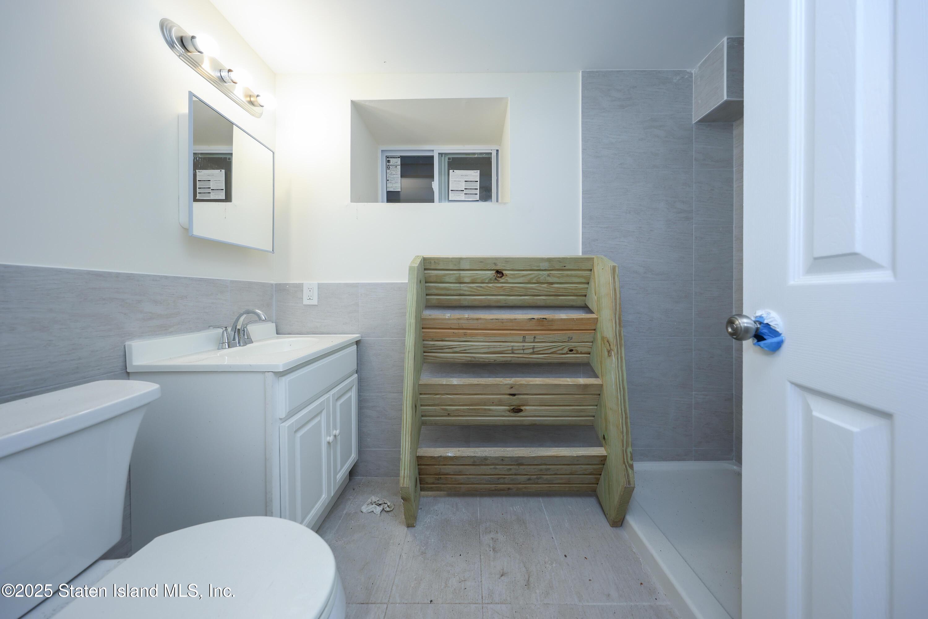 76 Simonson Avenue Staten Island, NY 10303 - Photo 16 of 21 a bathroom with a sink toilet and vanity
