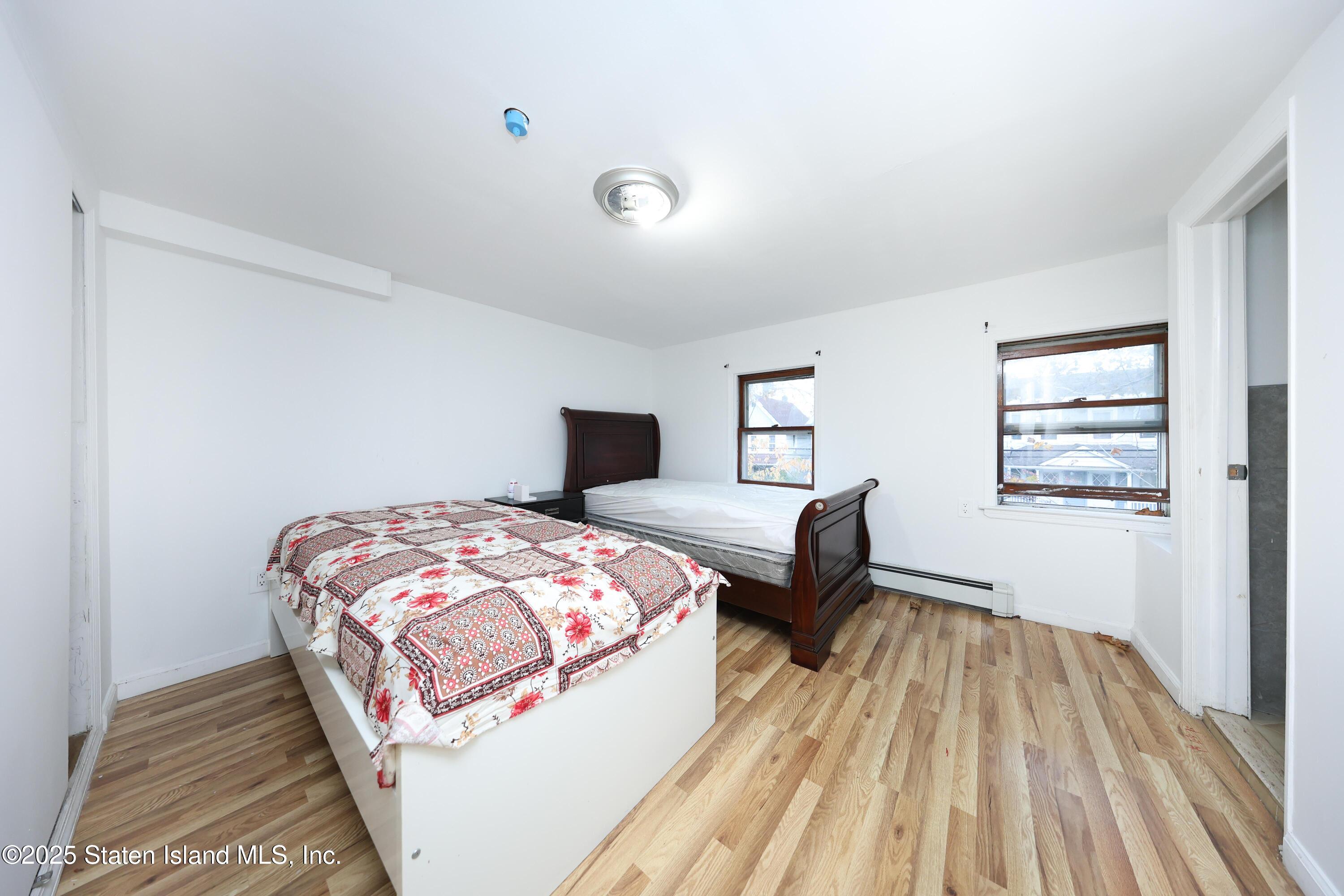 76 Simonson Avenue Staten Island, NY 10303 - Photo 5 of 21 a bedroom with a bed and wooden floor