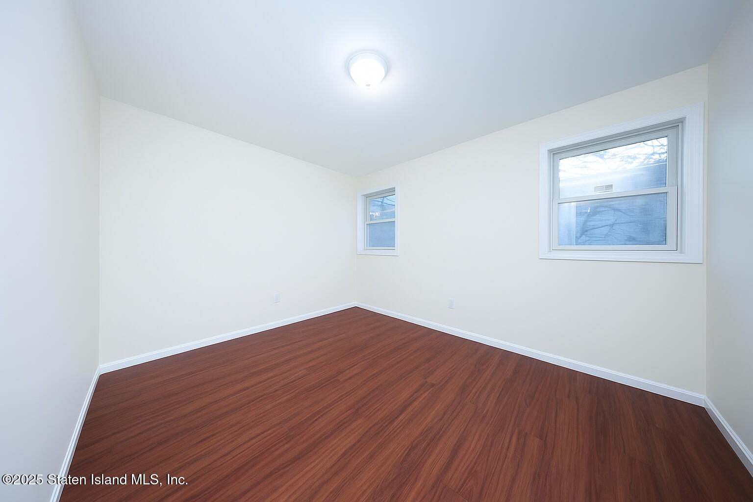 76 Simonson Avenue Staten Island, NY 10303 - Photo 7 of 21 an empty room with wooden floor and windows