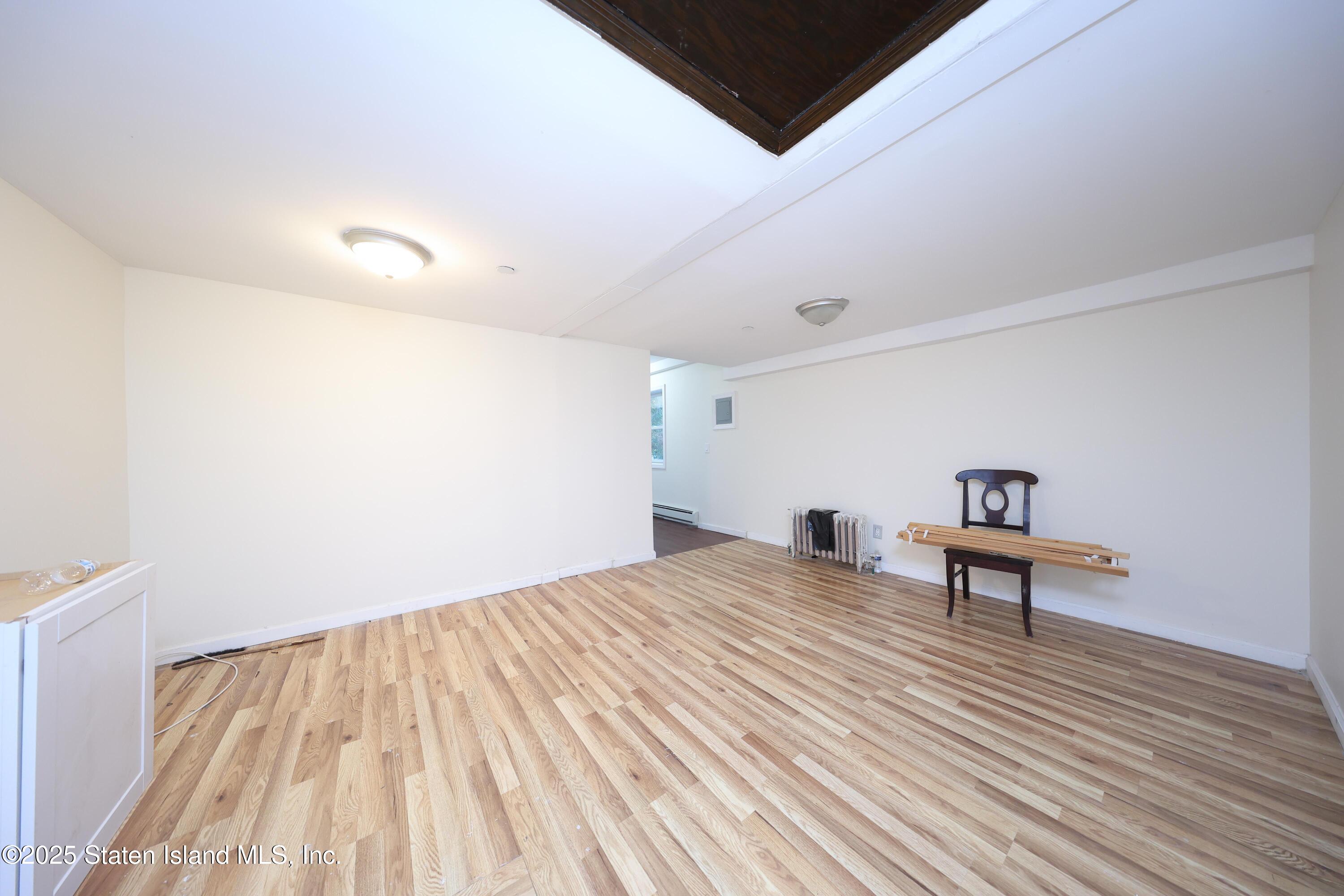 76 Simonson Avenue Staten Island, NY 10303 - Photo 9 of 21 a bedroom with a bed and a painting on the wall