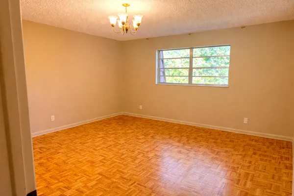 a view of a room with wooden floor