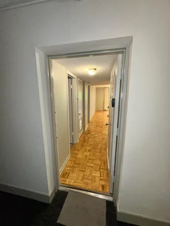 a view of hallway with wooden floor