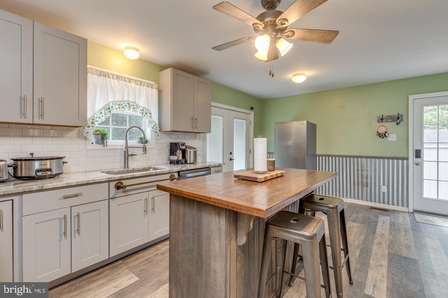 33 Laurel Road Millville, NJ 08332 - Photo 12 of 37 a kitchen with stainless steel appliances granite countertop a stove a sink dishwasher and a refrigerator with wooden floor