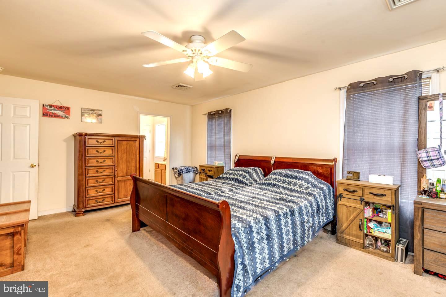 33 Laurel Road Millville, NJ 08332 - Photo 21 of 37 a bedroom with a bed and a chandelier