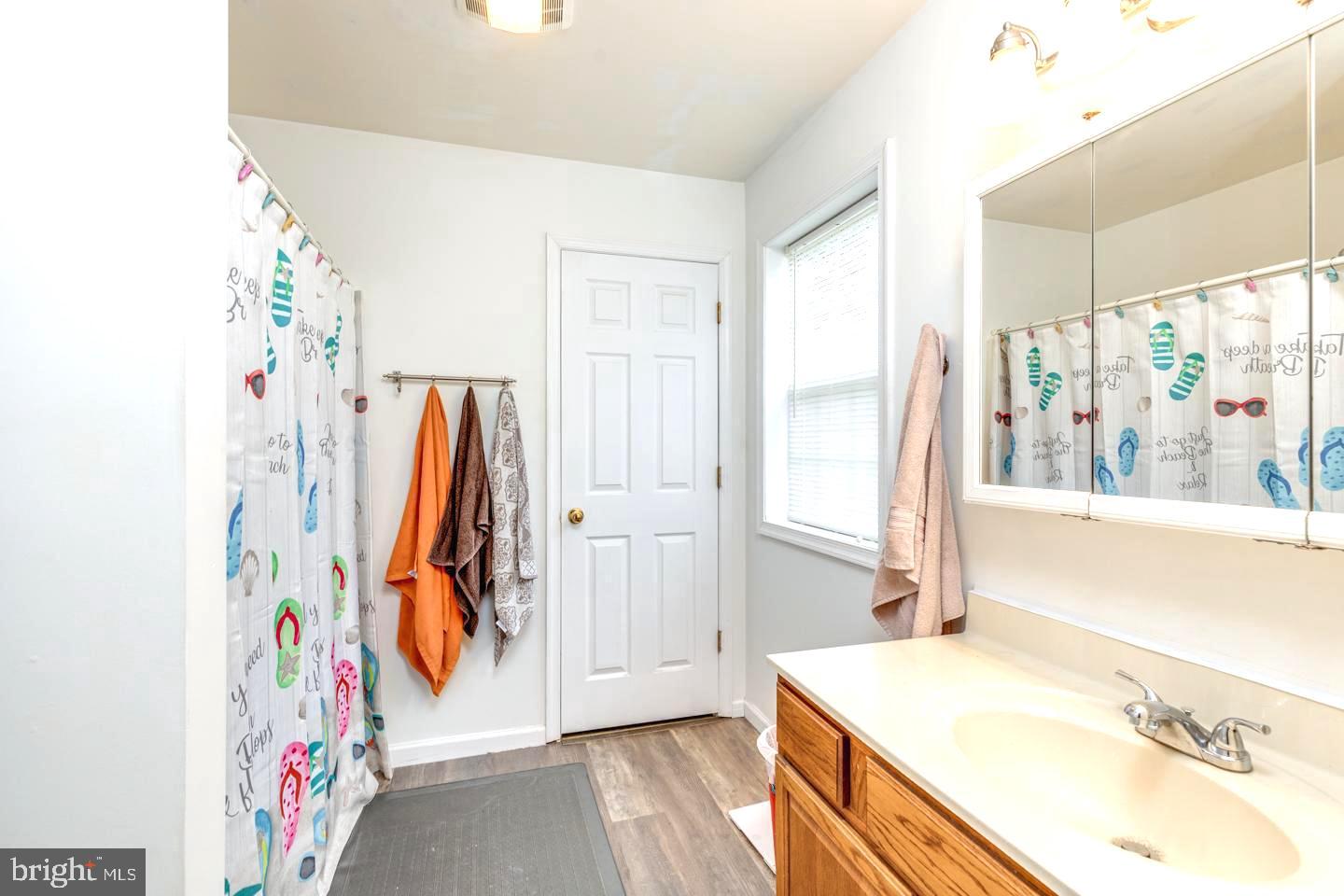 33 Laurel Road Millville, NJ 08332 - Photo 22 of 37 a view of bathroom with a tub sink and a mirror