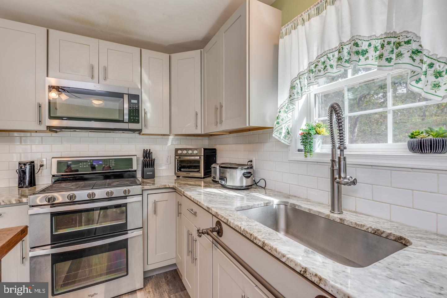 33 Laurel Road Millville, NJ 08332 - Photo 10 of 37 a kitchen with granite countertop a sink stainless steel appliances and cabinets