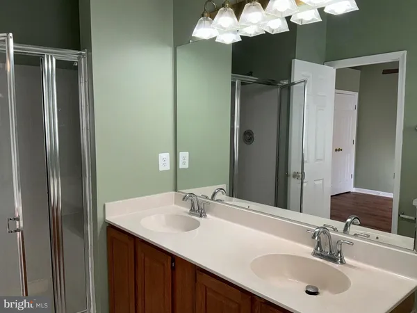 a bathroom with a sink double vanity and a mirror