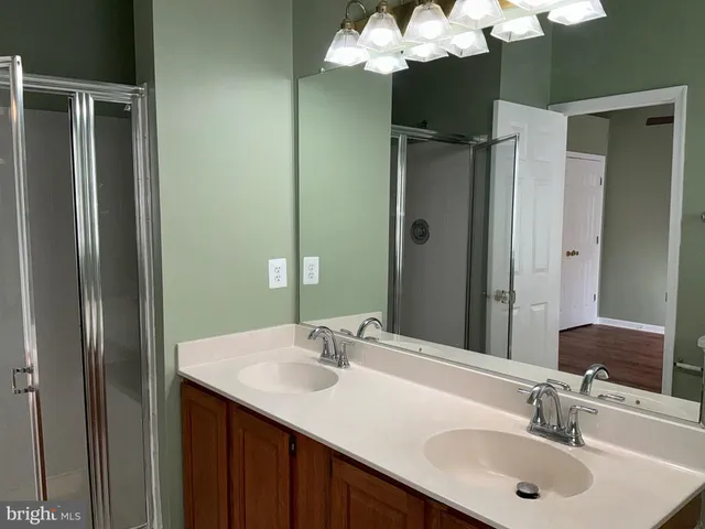 a bathroom with a sink double vanity and a mirror