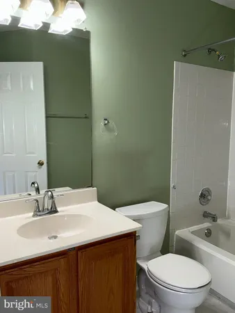 a bathroom with a sink a toilet and mirror