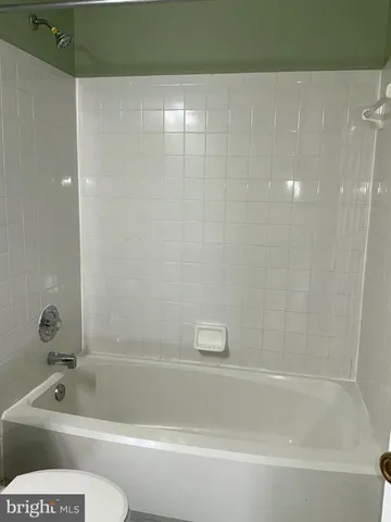 a bathroom with a toilet and a bathtub