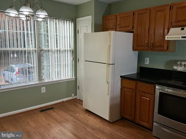 a white refrigerator freezer sitting inside of a kitchen