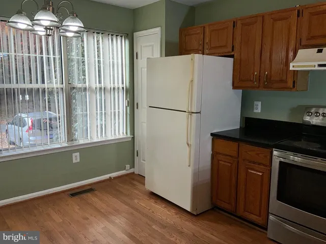 a white refrigerator freezer sitting inside of a kitchen