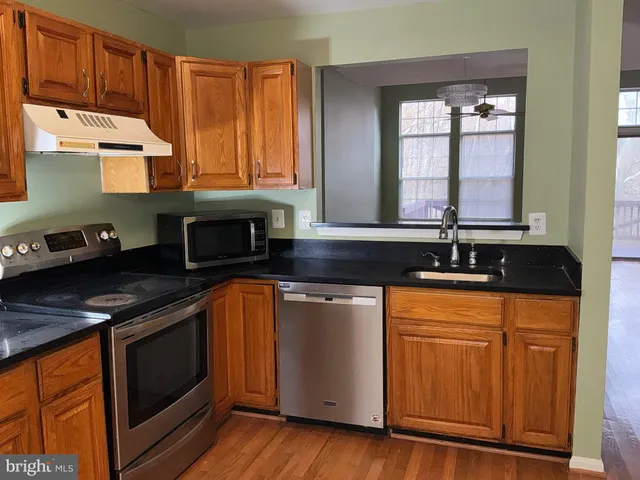 a kitchen that has a sink and a stove