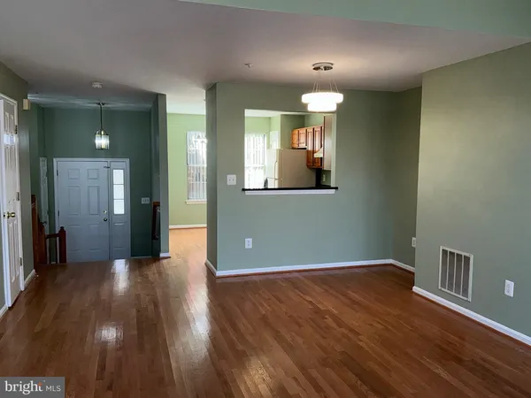 wooden floor in an empty room with a mirror