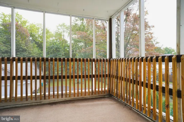 a front view of a house with a garden and parking