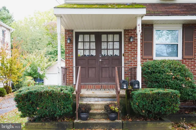 a view of staircase with wooden floor and white walls