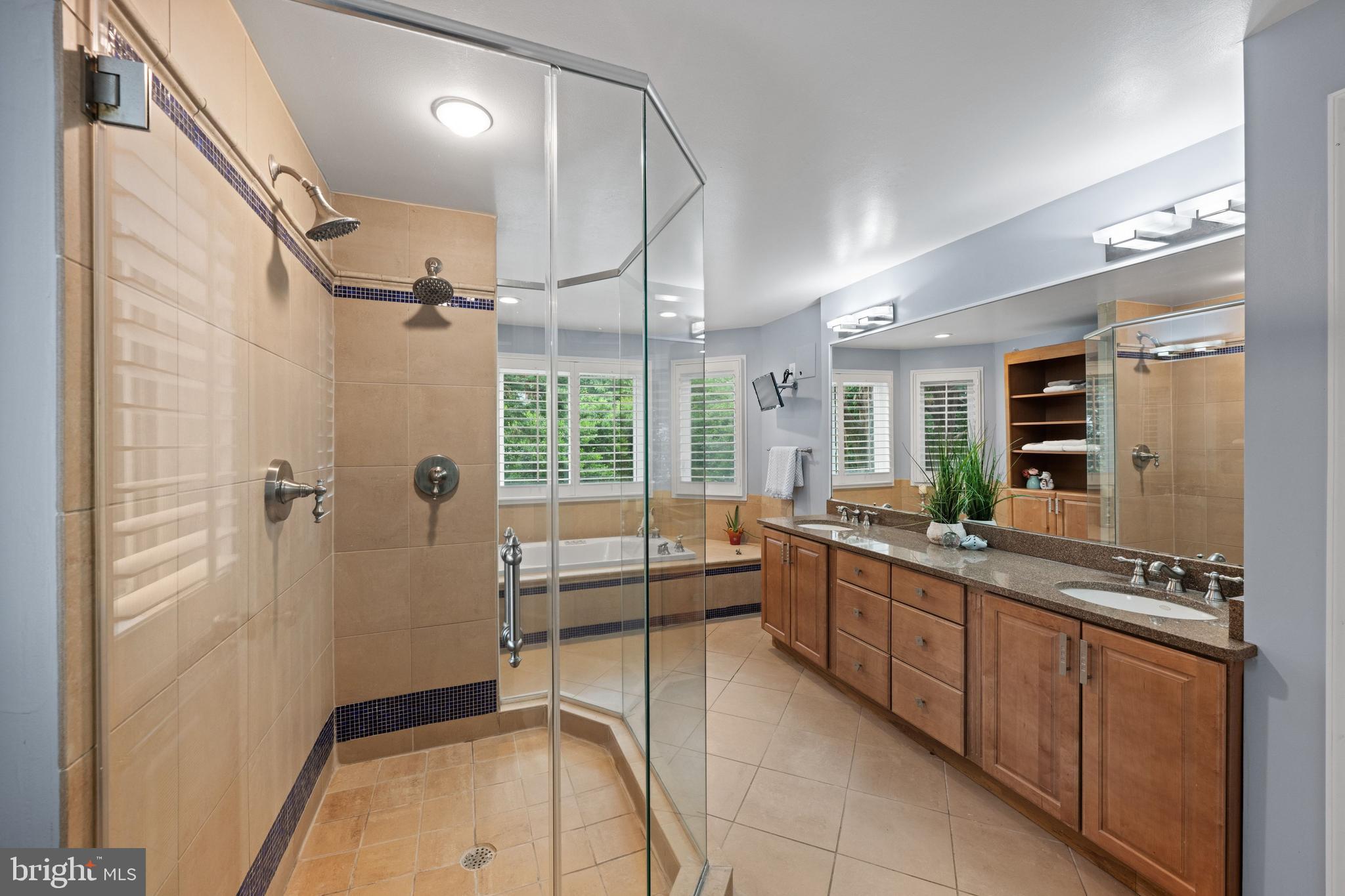 3529 Yuma Street Northwest Washington, DC 20008 - Photo 28 of 46 a large bathroom with a glass door shower a sink and a mirror