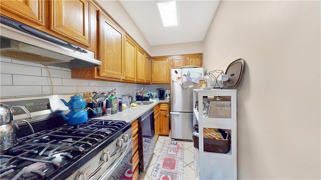9729 4th Avenue, Unit 3C Brooklyn, NY 11209 - Photo 6 of 10 a kitchen with furniture and a stove