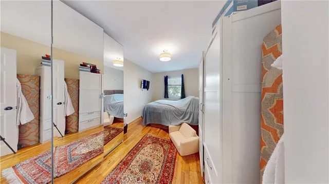 a bedroom with a bed and a mirror