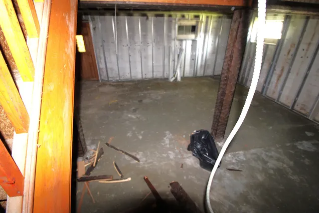 a living room with furniture a table and large window