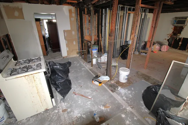 a view of a livingroom with furniture and floor to ceiling window